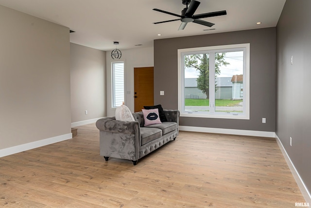 living room with ceiling fan and light wood-type flooring