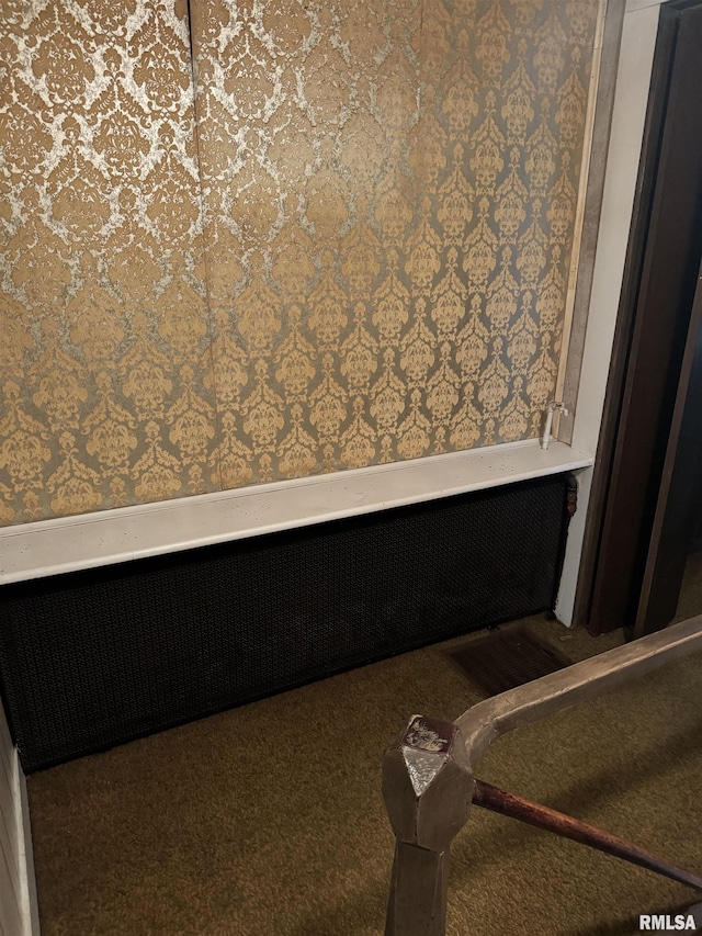 unfurnished bedroom with visible vents, carpet flooring, radiator heating unit, and wallpapered walls