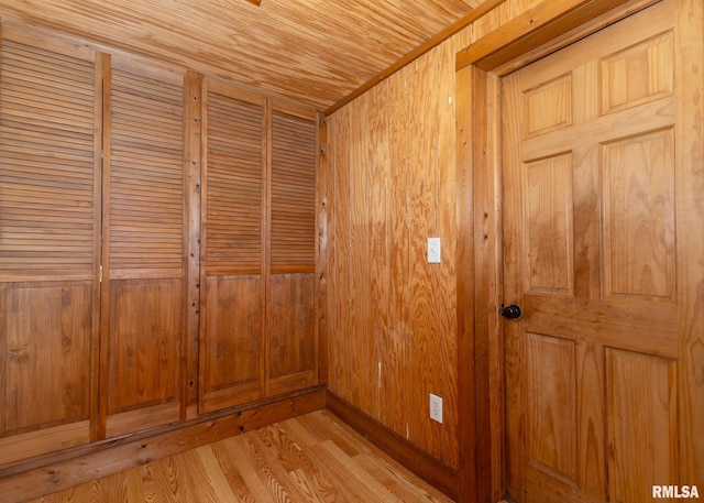 interior details with hardwood / wood-style flooring and wooden walls