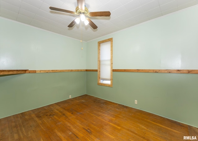 unfurnished room featuring ceiling fan, hardwood / wood-style flooring, and crown molding