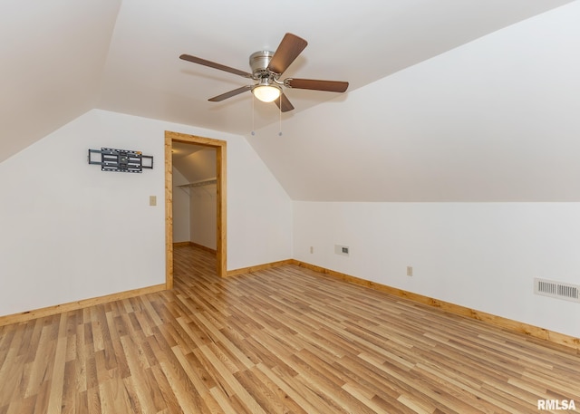 additional living space featuring ceiling fan, light wood-type flooring, and vaulted ceiling