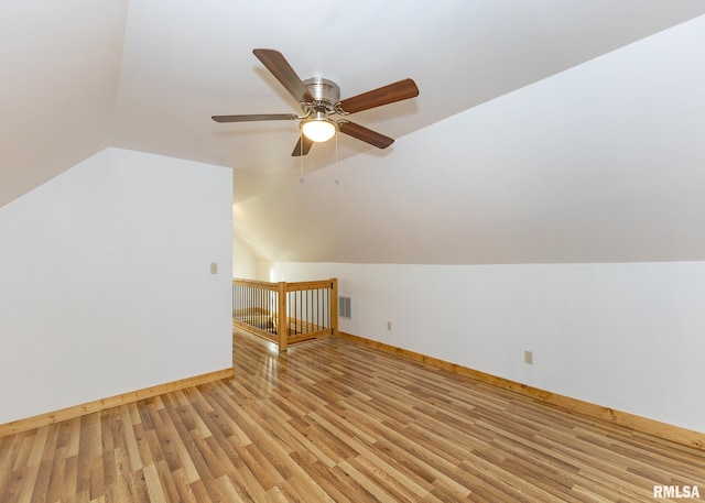 additional living space with light wood-type flooring, vaulted ceiling, and ceiling fan