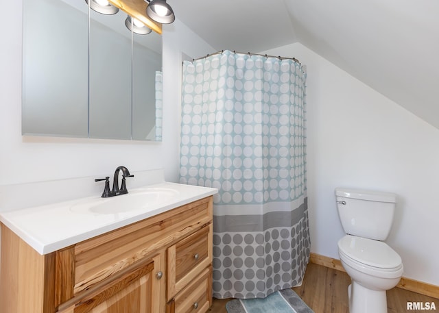 bathroom with vanity, toilet, wood-type flooring, walk in shower, and vaulted ceiling