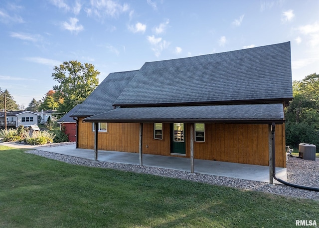 back of house featuring a yard and central air condition unit