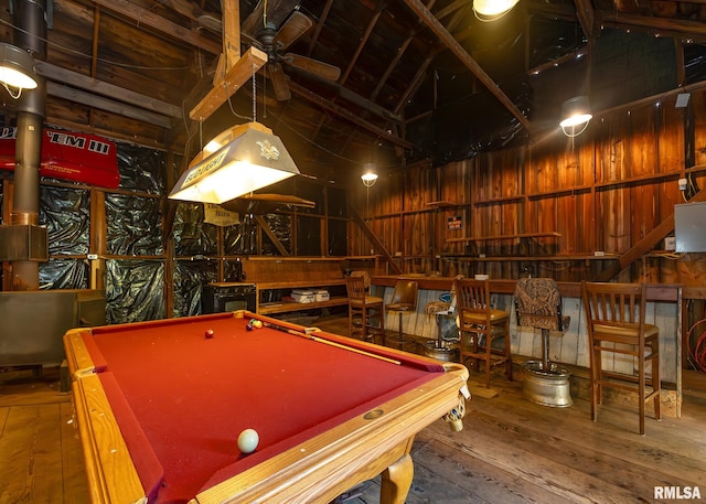 game room featuring pool table, lofted ceiling, wood walls, and hardwood / wood-style flooring