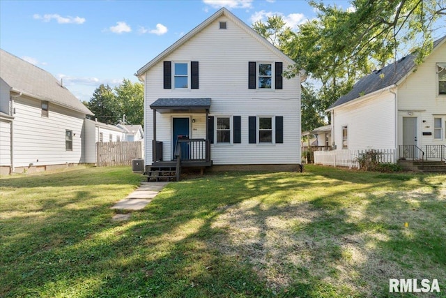 rear view of house with a yard