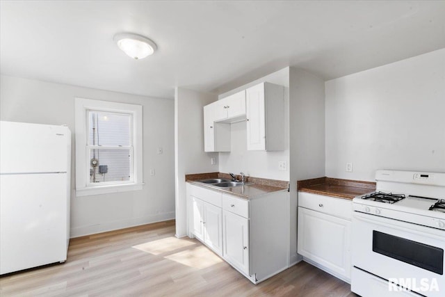 kitchen with white cabinets, white appliances, light hardwood / wood-style floors, and sink