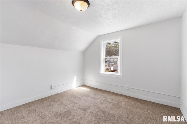 bonus room featuring carpet flooring, a textured ceiling, and vaulted ceiling