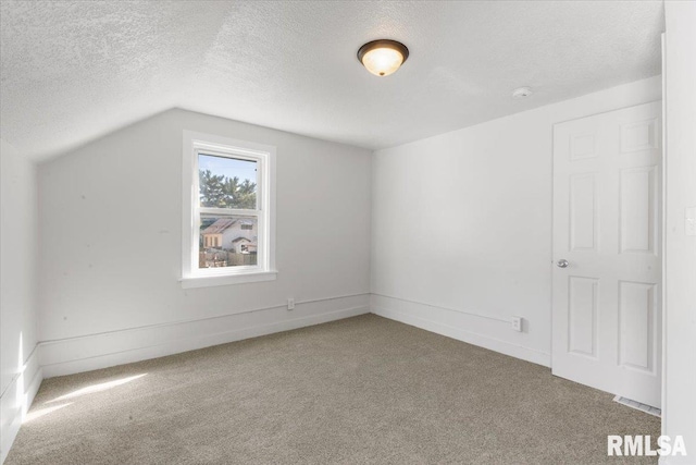 bonus room featuring a textured ceiling, vaulted ceiling, and carpet