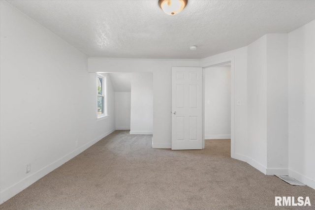 unfurnished bedroom with light carpet and a textured ceiling