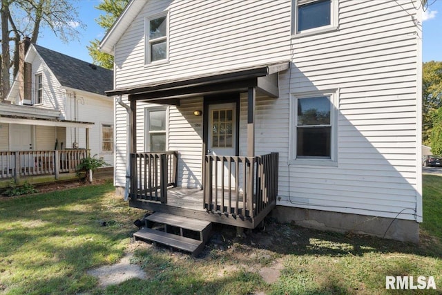 doorway to property with a lawn