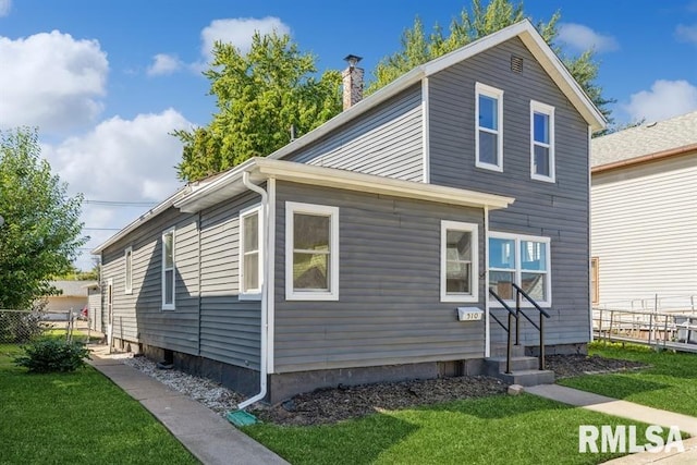 view of side of home with a lawn