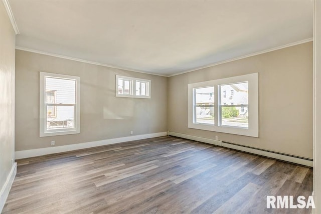 empty room featuring light wood-type flooring, ornamental molding, and a healthy amount of sunlight