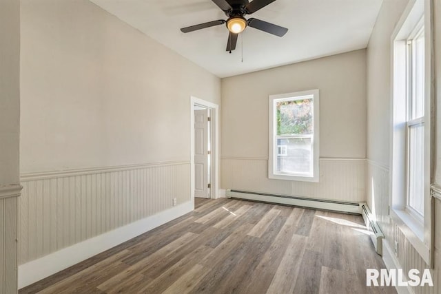 unfurnished room with a baseboard radiator, light hardwood / wood-style floors, and ceiling fan