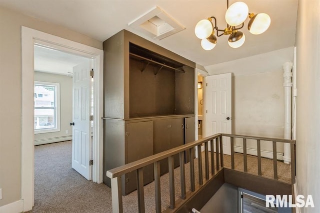 hall with carpet floors, an inviting chandelier, and a baseboard radiator