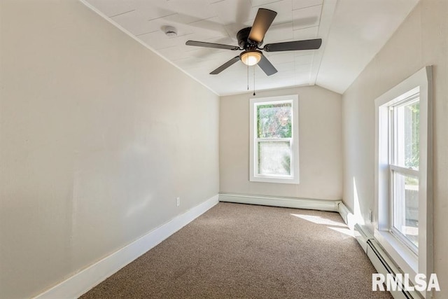 empty room featuring carpet floors, vaulted ceiling, ceiling fan, and a baseboard radiator