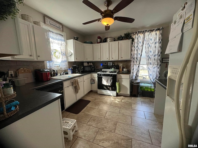 kitchen featuring plenty of natural light, gas range gas stove, decorative backsplash, and white cabinetry