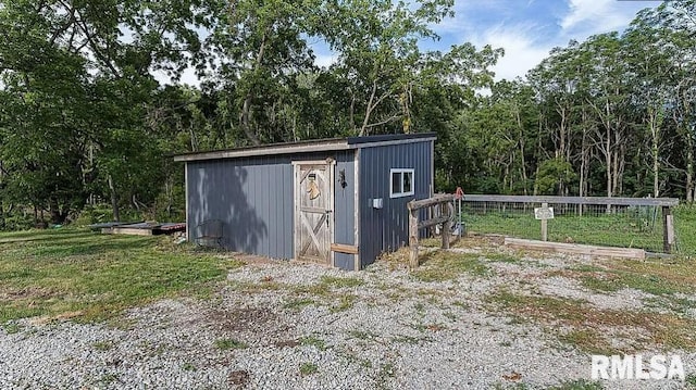 view of shed with fence