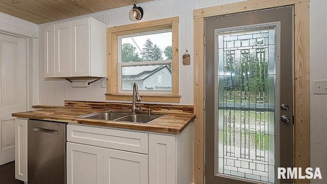 kitchen with butcher block countertops, white cabinets, and stainless steel dishwasher