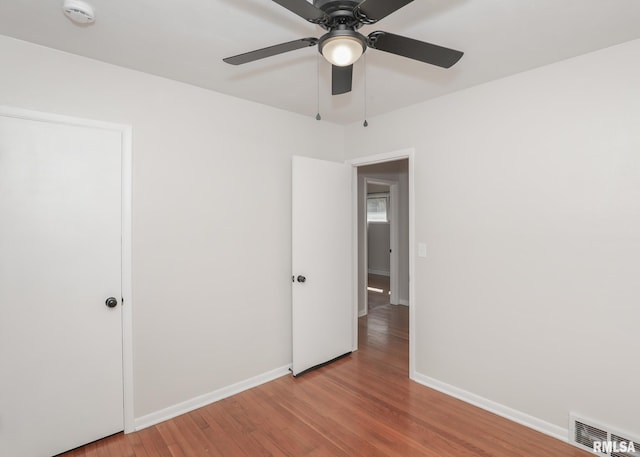 unfurnished bedroom featuring light wood-type flooring and ceiling fan