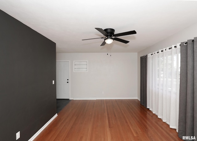 spare room with ceiling fan and hardwood / wood-style flooring