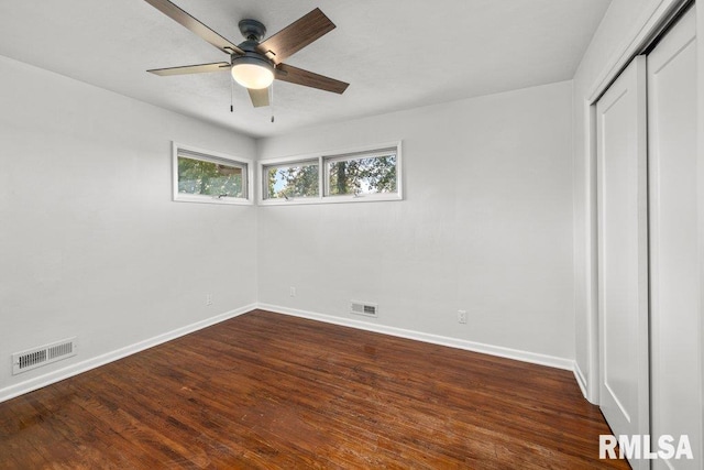 unfurnished bedroom featuring ceiling fan, a closet, and dark hardwood / wood-style floors