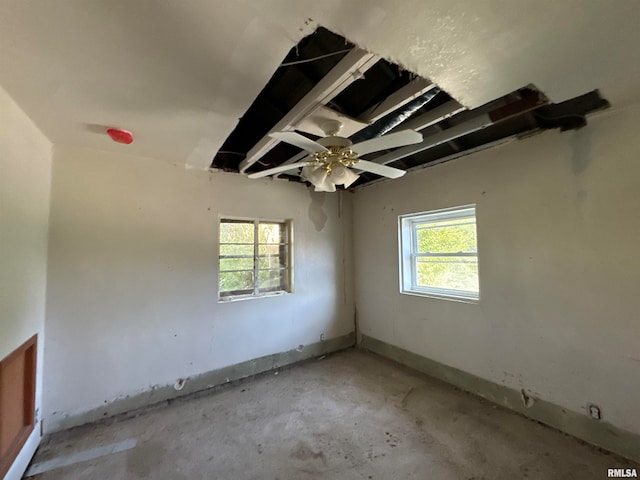 spare room with a wealth of natural light and ceiling fan