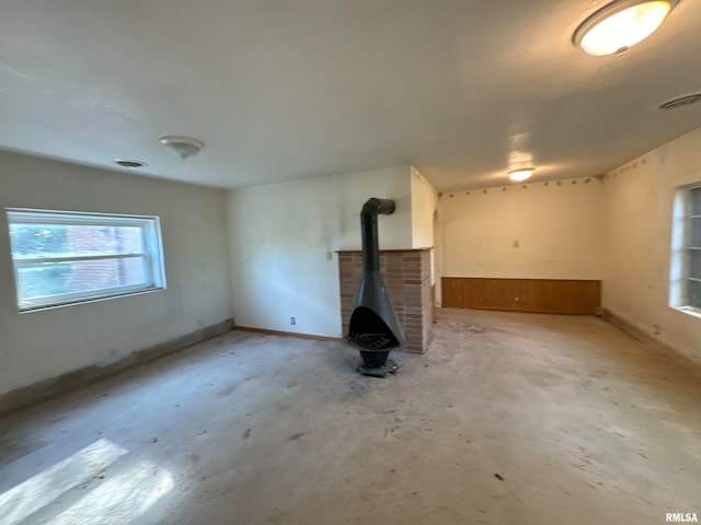 unfurnished living room featuring a wood stove