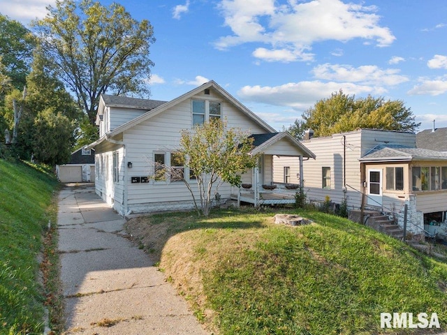 bungalow-style home with a front yard