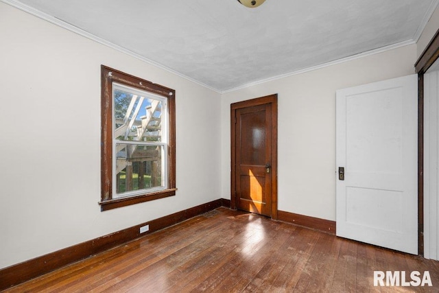 unfurnished bedroom with crown molding and dark hardwood / wood-style flooring