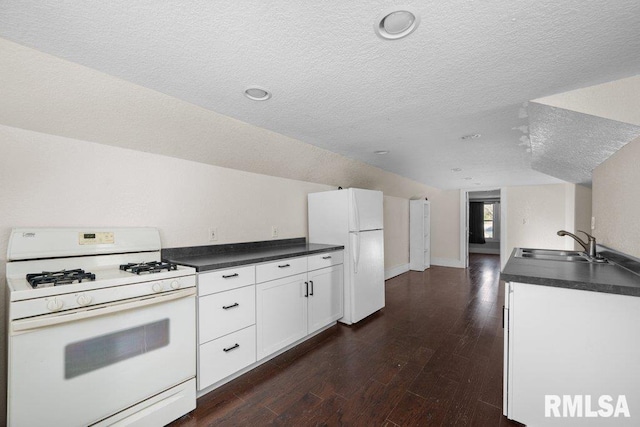 kitchen with white cabinets, sink, white appliances, a textured ceiling, and dark hardwood / wood-style floors