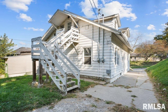 view of property exterior with a lawn