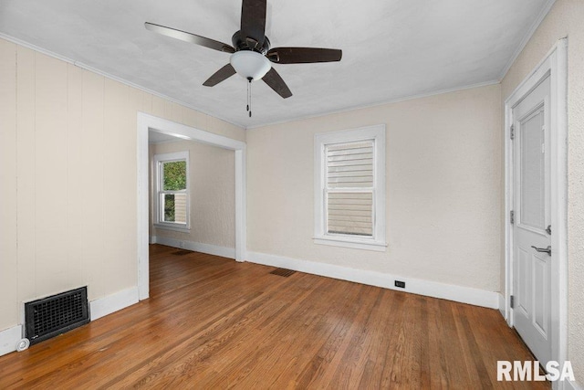 unfurnished room featuring crown molding, hardwood / wood-style floors, and ceiling fan