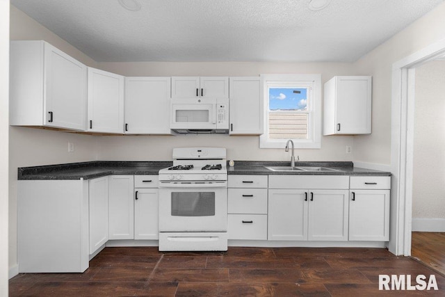 kitchen with dark hardwood / wood-style floors, sink, white appliances, and white cabinetry