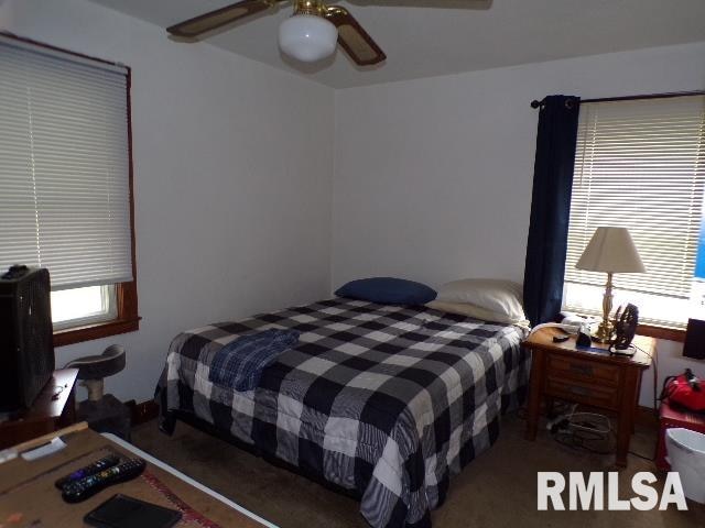 carpeted bedroom featuring ceiling fan