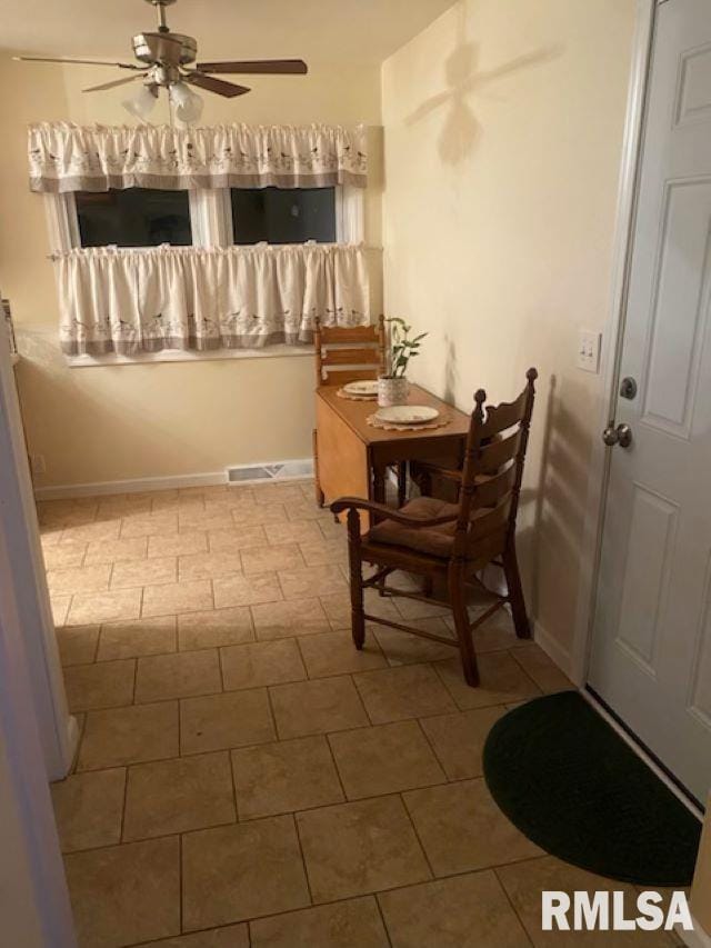 tiled dining space featuring ceiling fan