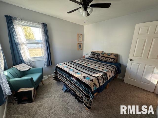 carpeted bedroom with ceiling fan