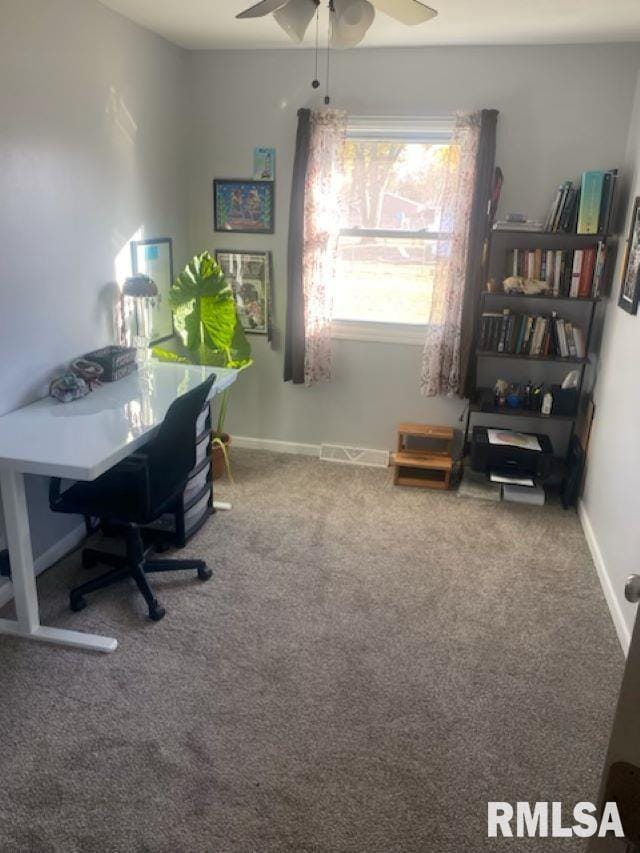 carpeted home office featuring ceiling fan