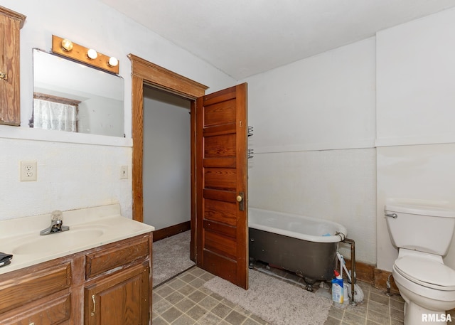 bathroom featuring a bathtub, vanity, and toilet