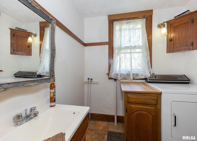 bathroom with washer / clothes dryer and sink