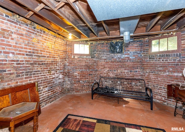 basement featuring brick wall and a wealth of natural light