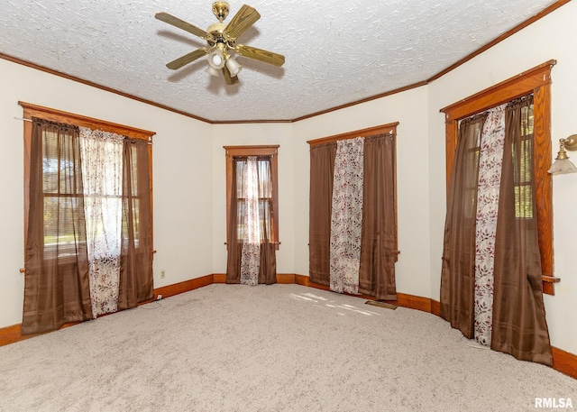 unfurnished bedroom with ceiling fan, ornamental molding, a textured ceiling, and carpet flooring