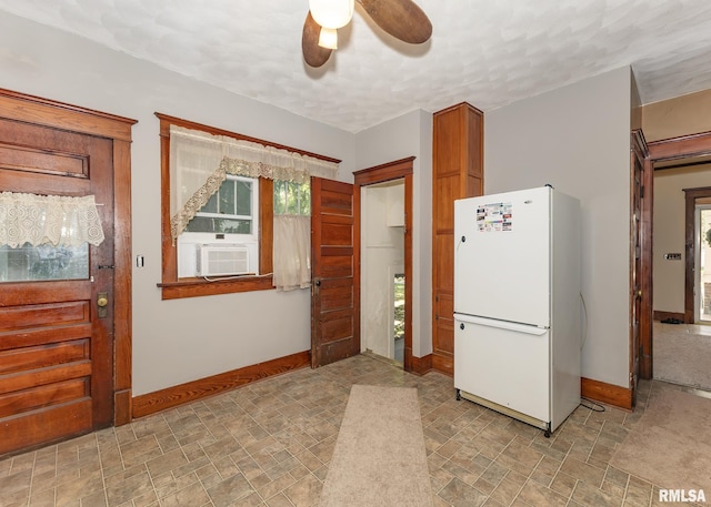 kitchen with cooling unit, plenty of natural light, ceiling fan, and white fridge