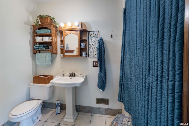 bathroom featuring tile patterned flooring, sink, and toilet