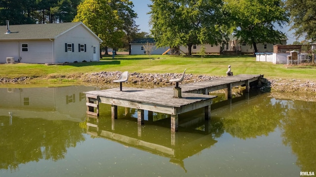 dock area with a lawn, a water view, and central AC