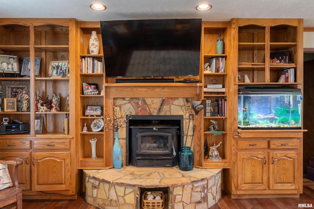 living room with dark hardwood / wood-style flooring and a wood stove