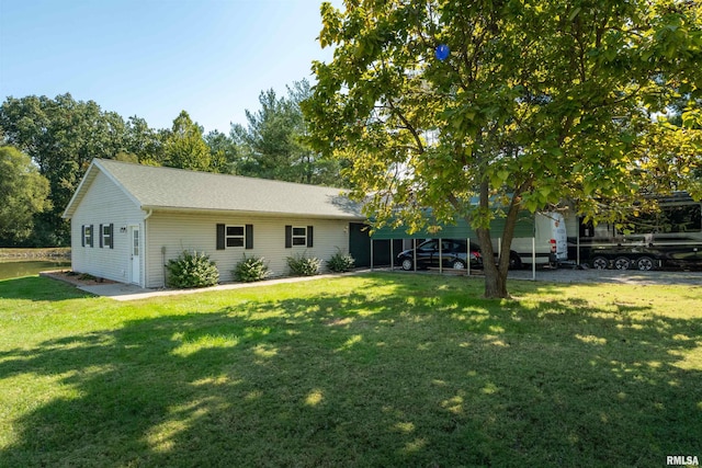 view of front facade with a carport and a front lawn