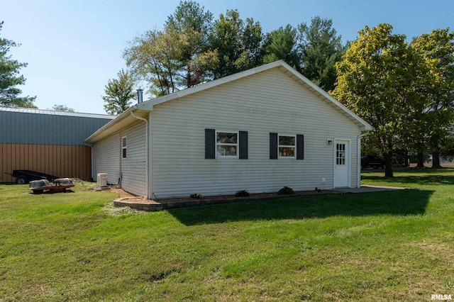 rear view of property with a yard