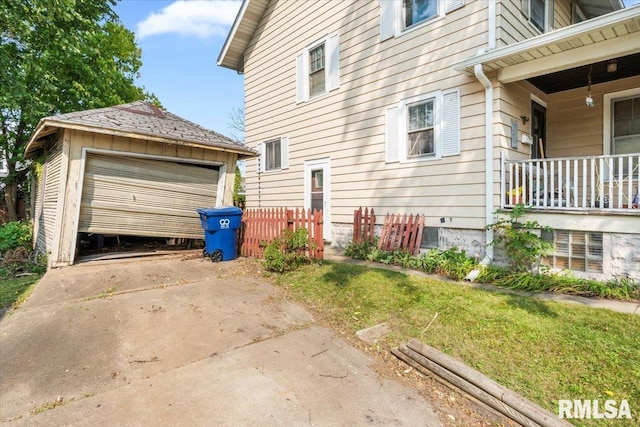 view of side of home with a garage and an outdoor structure