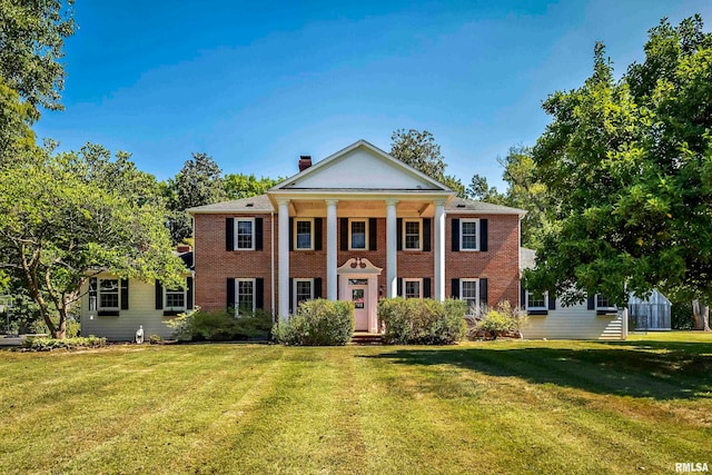 neoclassical / greek revival house with a front lawn